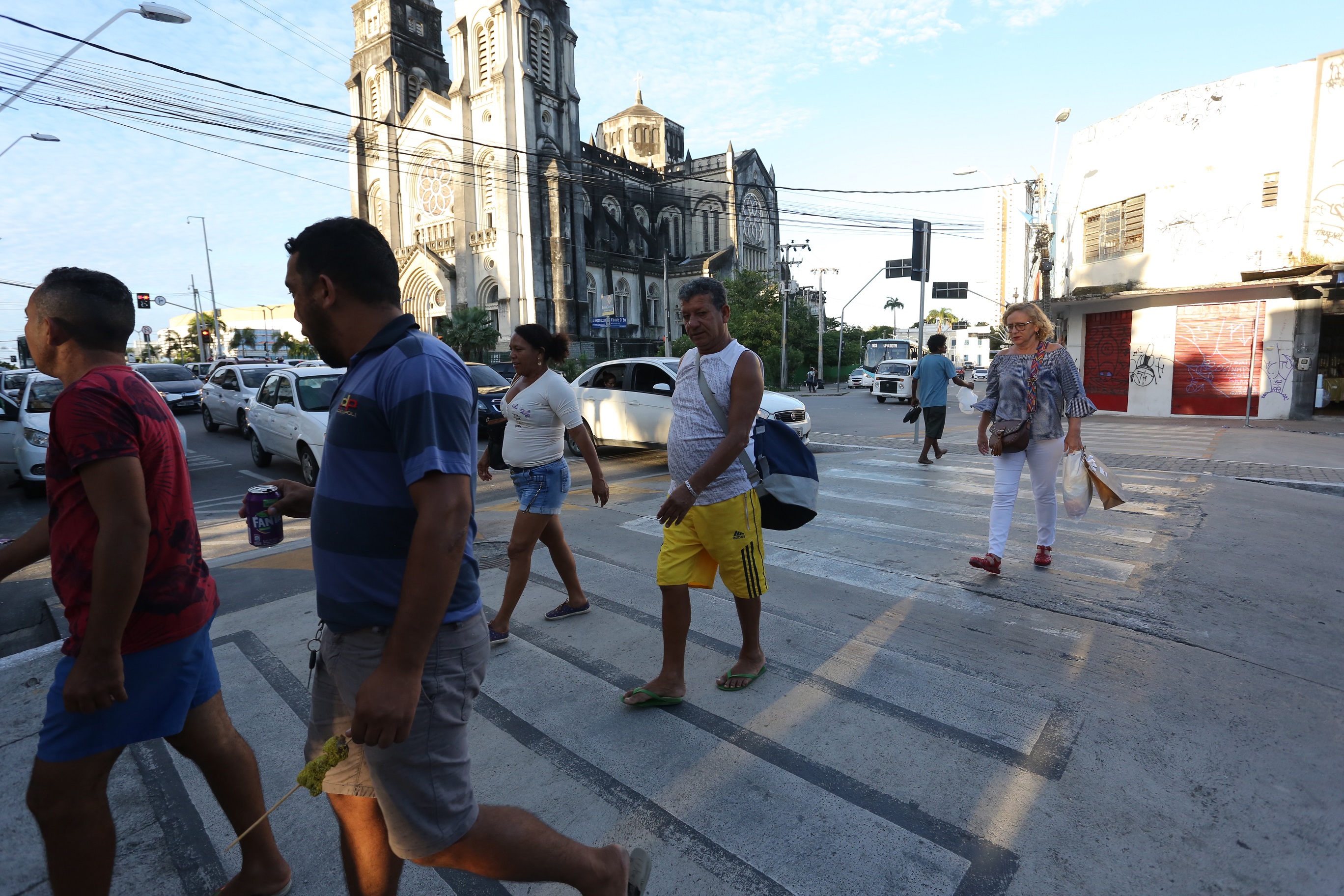 pessoas aravessam faixa de pedestre